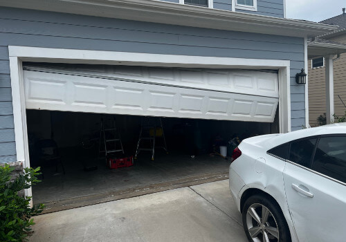 A white garage door off track on a home in Peachtree city GA